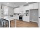 Bright kitchen featuring white cabinets, stainless steel appliances, an island with seating, and stylish backsplash at 3010 Garner Rd # 102, Raleigh, NC 27610