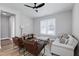 Well-lit living room with hardwood floors, seating, ceiling fan, and a cozy ambiance at 3010 Garner Rd # 102, Raleigh, NC 27610