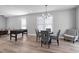 Well-lit living space with a foosball table, dining area, and comfortable seating at 3010 Garner Rd # 102, Raleigh, NC 27610