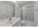 Bright bathroom features a shower with sliding glass doors, a large mirror, and tiled floors at 3208 Marblewood Ct, Raleigh, NC 27604