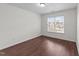 Well-lit bedroom offers wood-look floors and a large window with a peaceful outdoor view at 3208 Marblewood Ct, Raleigh, NC 27604