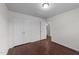 Cozy bedroom features wood-look floors, a double-door closet, and a bathroom entrance at 3208 Marblewood Ct, Raleigh, NC 27604
