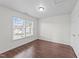 This bedroom has wood-look floors and large windows that provide plenty of natural light at 3208 Marblewood Ct, Raleigh, NC 27604