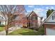 Charming two-story brick home with a well-manicured lawn, attached two-car garage, and mature landscaping at 3208 Marblewood Ct, Raleigh, NC 27604
