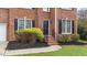 Close-up of the brick front entrance and tidy landscaping with black mulch and bright shrubbery at 3208 Marblewood Ct, Raleigh, NC 27604