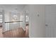 Bright hallway with wood-look floors, natural lighting, and white trim and staircase at 3208 Marblewood Ct, Raleigh, NC 27604