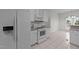 Bright kitchen with white appliances, tile flooring, and ample cabinet space at 3208 Marblewood Ct, Raleigh, NC 27604