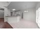 White kitchen with breakfast bar area leading into a bright dining space at 3208 Marblewood Ct, Raleigh, NC 27604