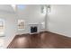 Bright living room with hardwood floors, a fireplace, and large windows at 3208 Marblewood Ct, Raleigh, NC 27604