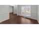 Bright living room featuring hardwood floors and a large window with natural light at 3208 Marblewood Ct, Raleigh, NC 27604