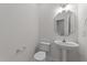 Cozy powder room with pedestal sink, toilet, mirror and chrome fixtures at 3208 Marblewood Ct, Raleigh, NC 27604