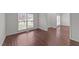 Bright room with wood-look flooring, fresh white paint and a large window allowing natural light to fill the space at 3208 Marblewood Ct, Raleigh, NC 27604