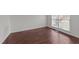 Bright room with wood-look flooring, fresh white paint and a large window allowing natural light to fill the space at 3208 Marblewood Ct, Raleigh, NC 27604