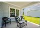 Cozy outdoor porch featuring comfortable seating, perfect for relaxing and enjoying the surrounding views at 340 Olde Liberty Dr, Youngsville, NC 27596