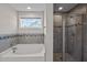 Bright bathroom with tiled shower and separate bathtub, perfect for relaxation at 340 Olde Liberty Dr, Youngsville, NC 27596
