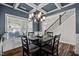 Dining room with a dark accent wall and a black dining table in front of a large window at 340 Olde Liberty Dr, Youngsville, NC 27596