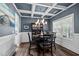 Elegant dining room with coffered ceiling, modern chandelier, and large window for ample natural light at 340 Olde Liberty Dr, Youngsville, NC 27596