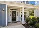 Inviting front porch with ample space for seating, decorative wreaths, and a tranquil ambiance at 340 Olde Liberty Dr, Youngsville, NC 27596