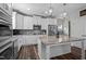 Modern kitchen with white cabinets, stainless steel appliances, gray backsplash and marble island at 340 Olde Liberty Dr, Youngsville, NC 27596