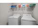 Bright laundry room with washer, dryer, and shelving for organized storage solutions at 340 Olde Liberty Dr, Youngsville, NC 27596