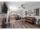 Bright living room featuring hardwood floors, a fireplace, and an open layout to the kitchen at 340 Olde Liberty Dr, Youngsville, NC 27596
