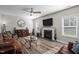 Bright living room with a fireplace, hardwood floors, and a ceiling fan for added comfort at 340 Olde Liberty Dr, Youngsville, NC 27596