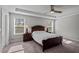 Spacious main bedroom featuring tray ceilings, plush carpet, and natural light from two windows at 340 Olde Liberty Dr, Youngsville, NC 27596
