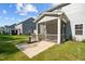 View of the screened in patio with stainless steel grill and a concrete patio at 340 Olde Liberty Dr, Youngsville, NC 27596