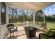 Inviting screened porch with cozy seating, fire pit and views of wooded backyard at 340 Olde Liberty Dr, Youngsville, NC 27596