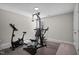 Home workout room with exercise bike and weight machine on a carpeted floor with padding at 340 Olde Liberty Dr, Youngsville, NC 27596