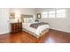 Cozy bedroom featuring hardwood floors, a comfortable bed, and plenty of natural light at 3721 Browning Pl, Raleigh, NC 27609