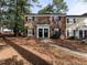 Charming brick townhome with black shutters and seasonal wreaths adorning the front doors at 3721 Browning Pl, Raleigh, NC 27609