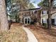 Charming brick townhome with black shutters and seasonal wreaths adorning the front doors at 3721 Browning Pl, Raleigh, NC 27609