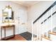 Bright foyer features a staircase with black handrail and decorative table with mirror at 3721 Browning Pl, Raleigh, NC 27609