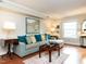 Comfortable living room with hardwood floors, a large sofa, and plenty of natural light at 3721 Browning Pl, Raleigh, NC 27609