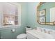 Powder room with lovely vanity and a large window providing ample natural light at 3924 Sunset Maple Ct, Raleigh, NC 27612