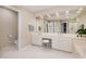 Bright bathroom featuring a double vanity, vanity chair, and large mirror at 3924 Sunset Maple Ct, Raleigh, NC 27612