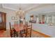 Elegant dining area featuring a chandelier and open view to the living room at 3924 Sunset Maple Ct, Raleigh, NC 27612