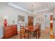 Bright dining room with chandelier, showcasing classic furnishings and decor at 3924 Sunset Maple Ct, Raleigh, NC 27612