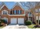 Charming brick two-story home featuring a two-car garage, manicured lawn, and inviting entrance at 3924 Sunset Maple Ct, Raleigh, NC 27612