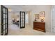 Hallway features warm neutral walls, complementing dark-framed doors that lead to other rooms and a light-colored carpet at 3924 Sunset Maple Ct, Raleigh, NC 27612