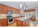Bright eat-in kitchen features a large island, hardwood floors, and stainless steel appliances at 3924 Sunset Maple Ct, Raleigh, NC 27612