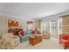 Bright living room featuring comfortable seating, large windows, and open access to other rooms at 3924 Sunset Maple Ct, Raleigh, NC 27612