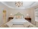 Large main bedroom features a tray ceiling, and a lovely chandelier at 3924 Sunset Maple Ct, Raleigh, NC 27612