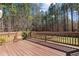 A spacious stained wooden back deck with railing, perfect for outdoor relaxation and entertainment at 40 Paddle Wheel Ct, Franklinton, NC 27525