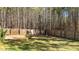 Backyard displaying a wooden privacy fence, green grass, and tree line at 40 Paddle Wheel Ct, Franklinton, NC 27525