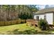 Backyard view displaying wood deck, landscaping, green lawn, and privacy fence at 40 Paddle Wheel Ct, Franklinton, NC 27525