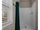 Bathroom features a tiled shower with window and a green shower curtain at 40 Paddle Wheel Ct, Franklinton, NC 27525