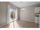 Bright dining area with sliding door access to the deck and chandelier lighting at 40 Paddle Wheel Ct, Franklinton, NC 27525