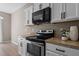 Stylish kitchen with stainless steel range and microwave, complemented by sleek countertops at 40 Paddle Wheel Ct, Franklinton, NC 27525